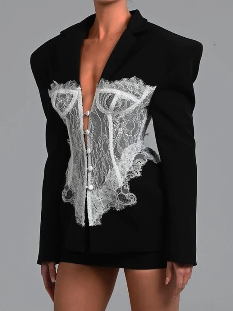 Black blazer with white lace detailing on a gray background