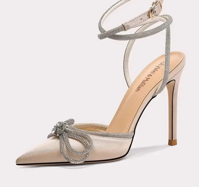 High-heeled shoe with decorative bow on a white background