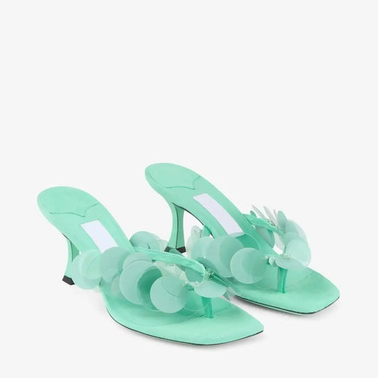 Aqua green heeled thong sandals with circular sequin embellishments.