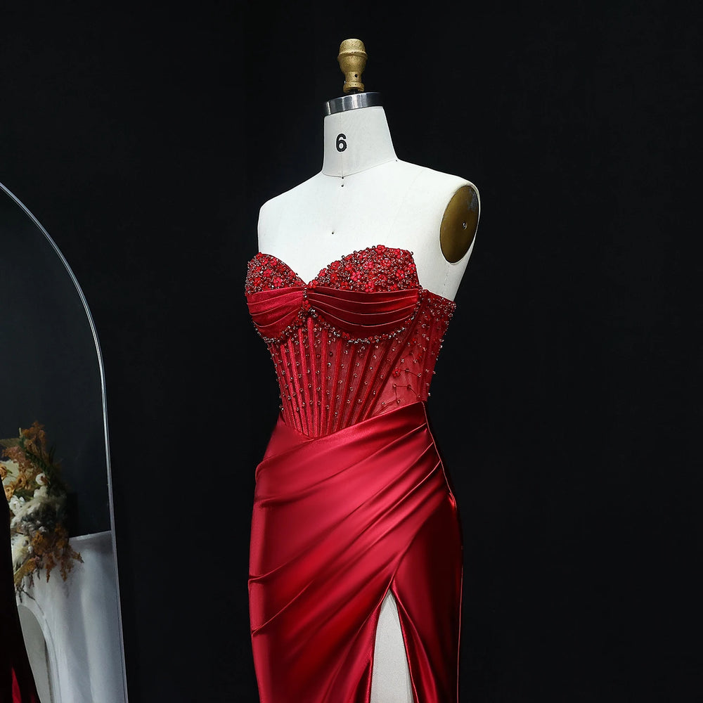 Red evening gown on a mannequin against a black background