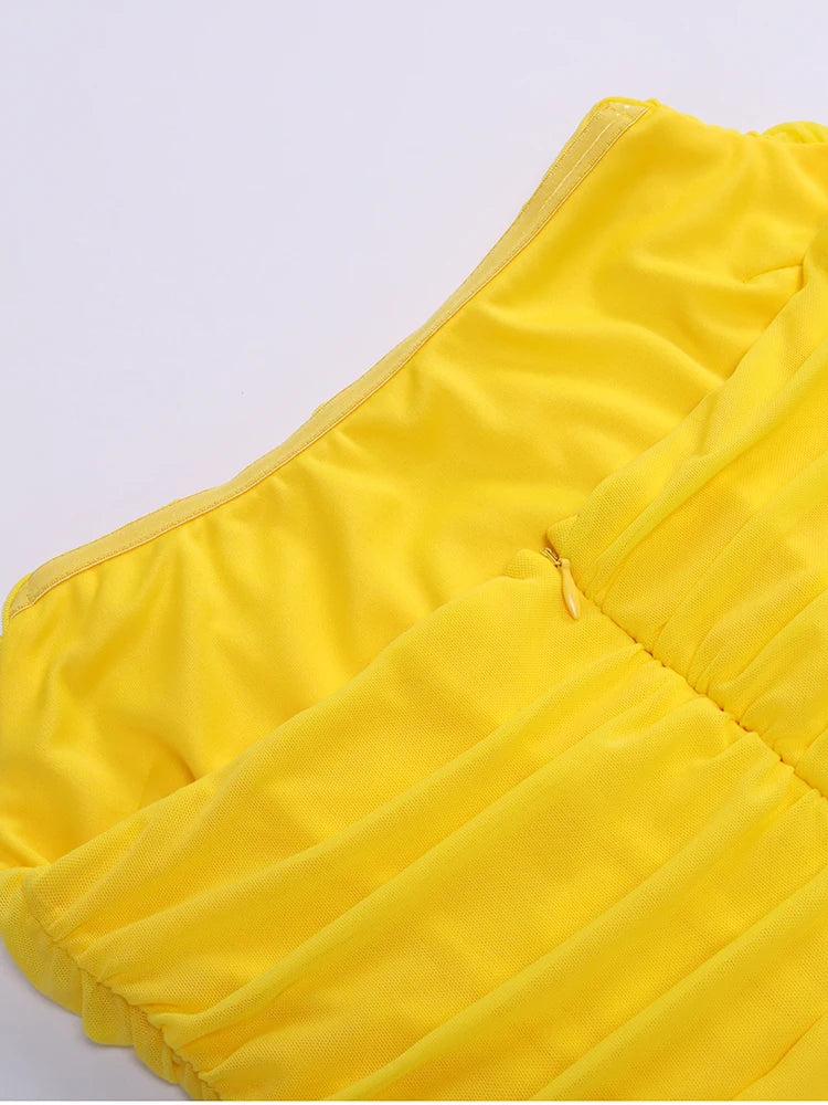 Yellow quilted jacket on a light gray background