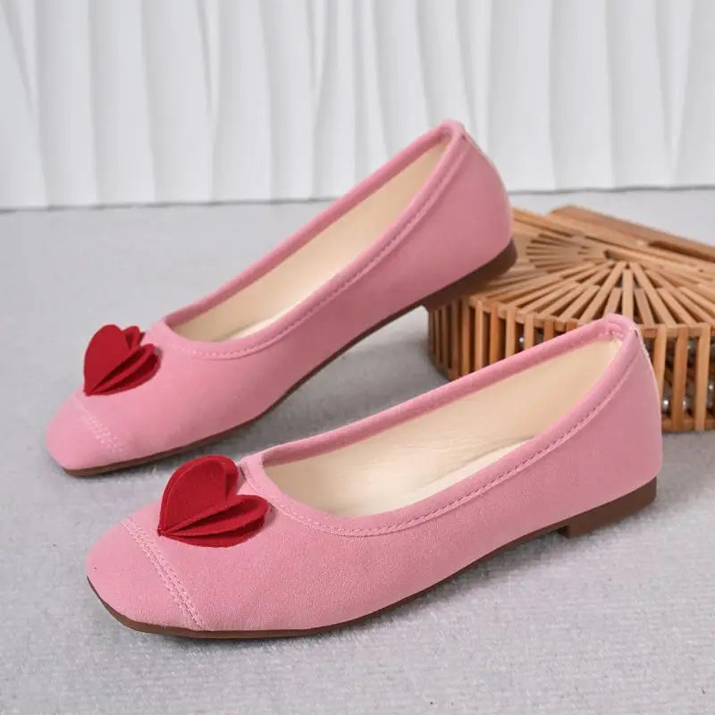 Pink ballet flats with red heart embellishment