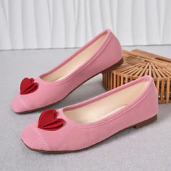 Pink ballet flats with red heart embellishment