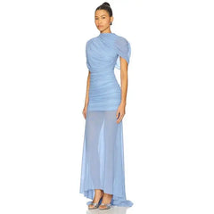Woman wearing a light blue evening gown on a white background