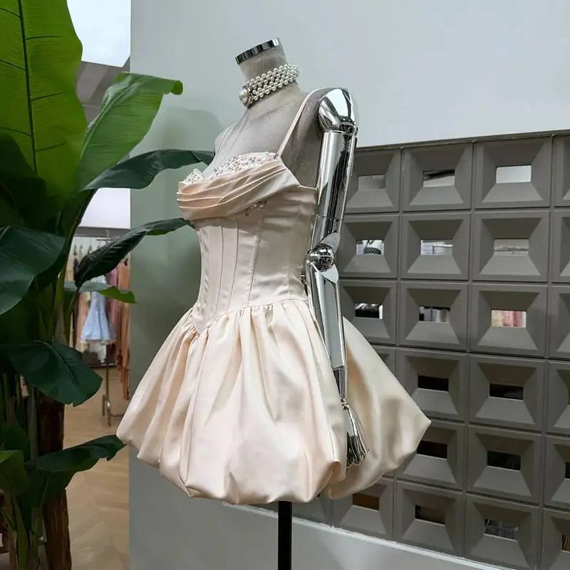 Side view of champagne sparkle strapless mini dress