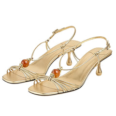 Gold metallic slingback heels with beaded embellishments and a square toe.