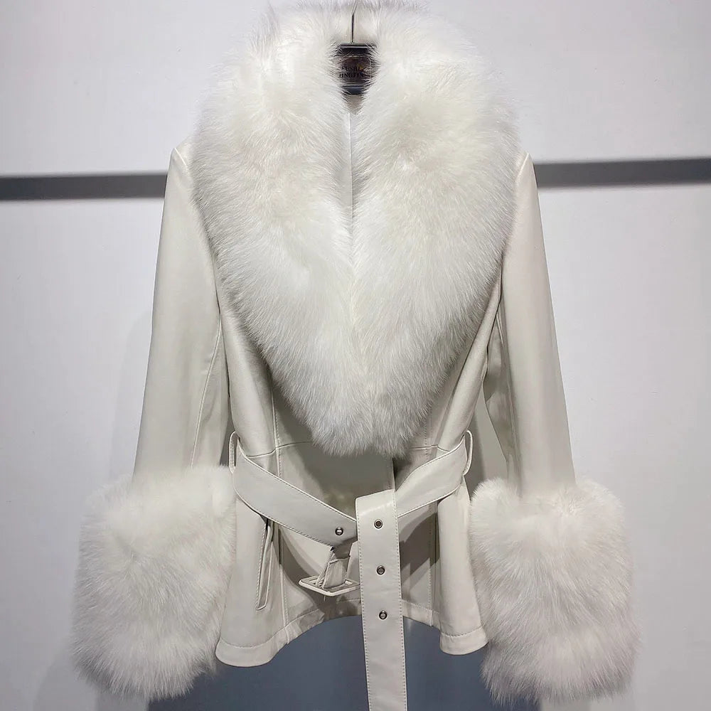 White coat with fur trim on a mannequin against a plain background