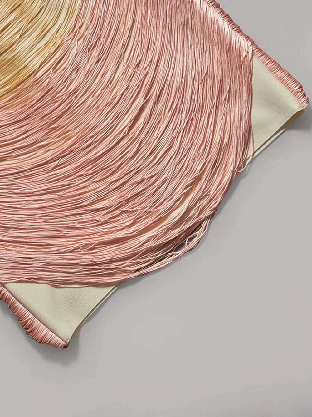 Close-up of a pink hair color swatch on a gray background