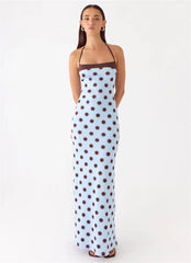 Woman wearing a polka dot dress on a white background