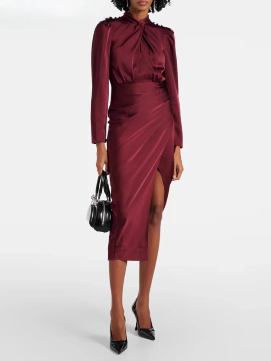 Woman wearing a burgundy dress with a black handbag