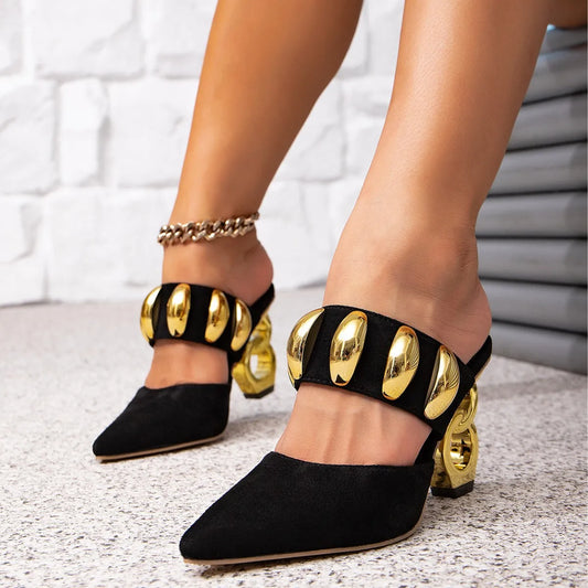 Pointed toe mule with sculptural gold heel and embellished strap detail.