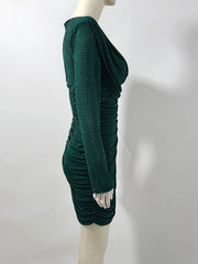 Green dress on a mannequin against a white background