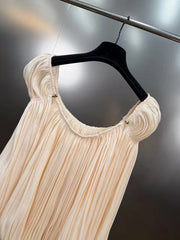 Beige dress on a black hanger against a dark background