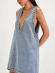 Denim dress with embellished neckline on a white background