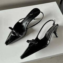  Pair of  pointed-toe slingback pumps with a buckle strap, showcasing their elegant design. Black . Golden atelier 4