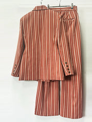 Back view of double breasted striped blazer and wide leg pants suit hanging