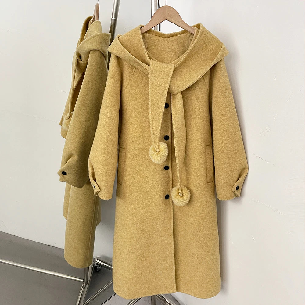 Hooded wool blend coat in yellow with a detachable pom-pom scarf.