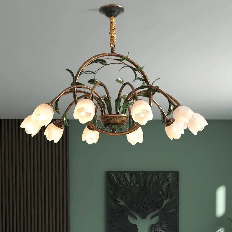 Vintage-style chandelier with frosted glass rose shades and green leaf detailing- drop hanging.