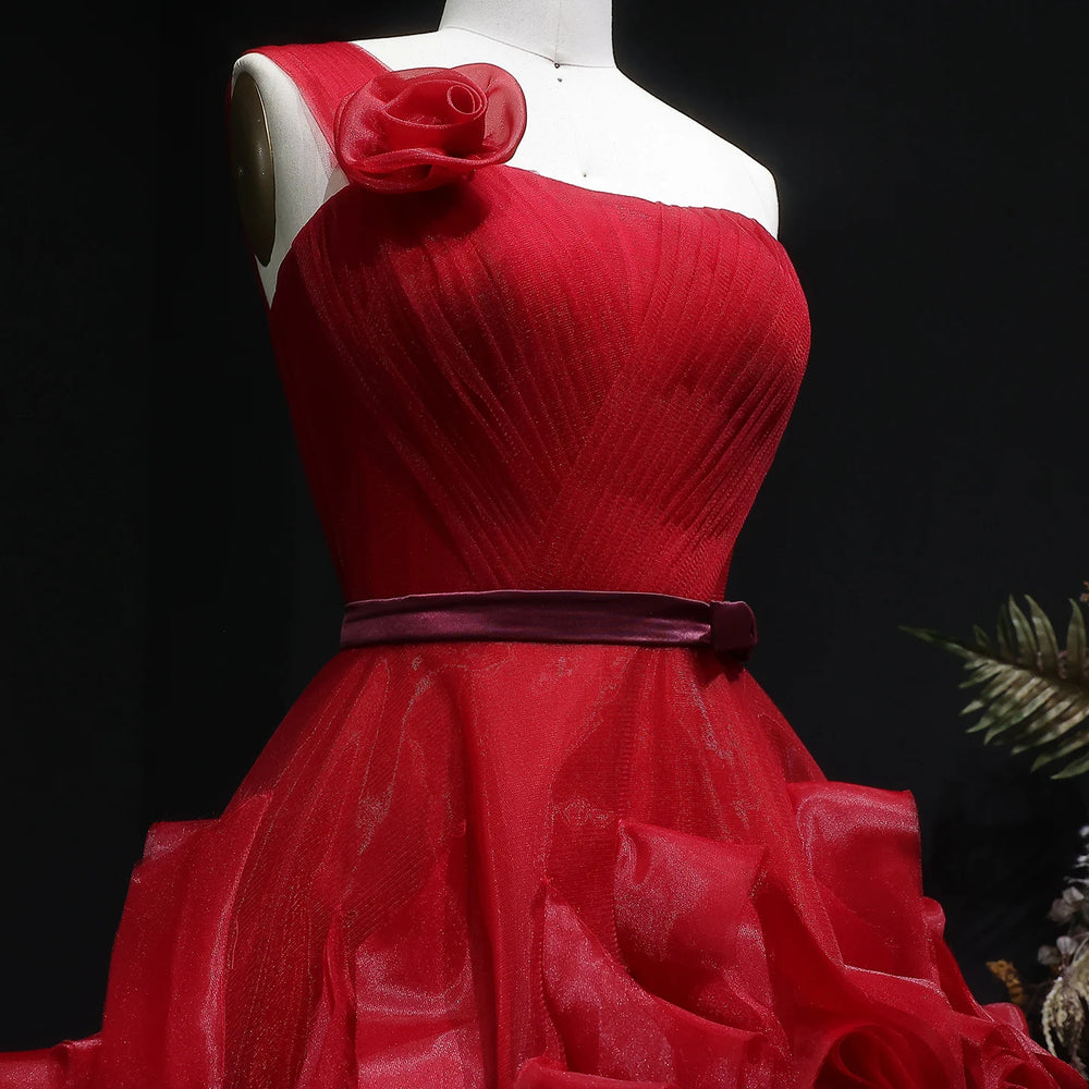 Red evening gown on a mannequin against a dark background
