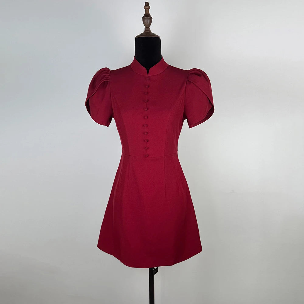 Red dress on a mannequin against a plain background