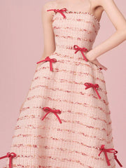 Strapless dress with red bows on a pink background