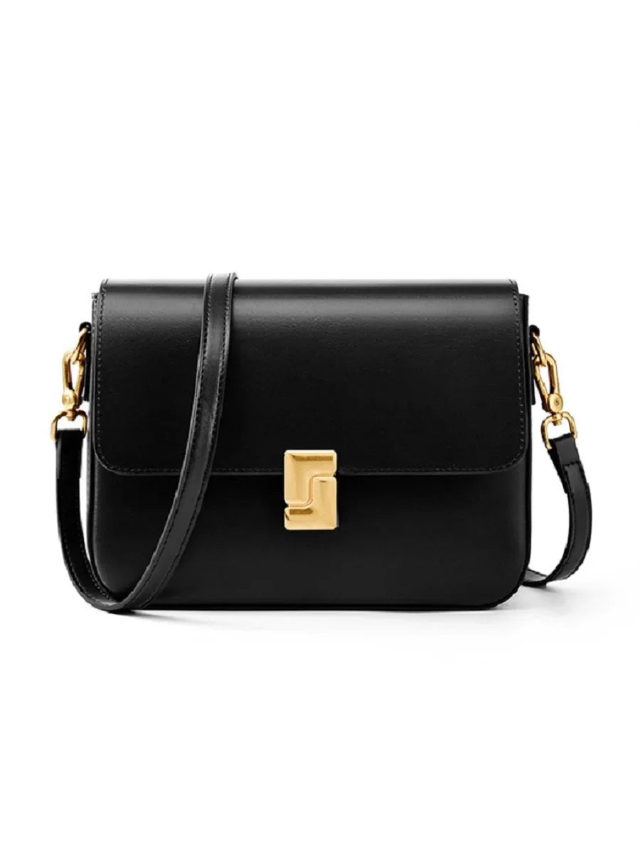 Black handbag with gold accents on a white background