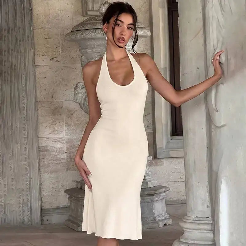 Model posing in a halter neck midi dress