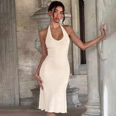Model posing in a halter neck midi dress