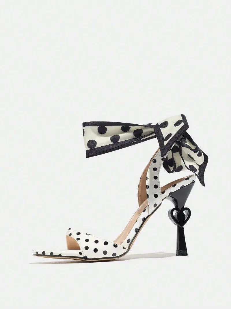Polka dot sandal with heart design on a white background
