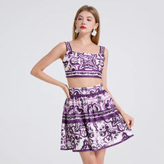 Woman wearing a purple and white patterned two-piece outfit on a light gray background