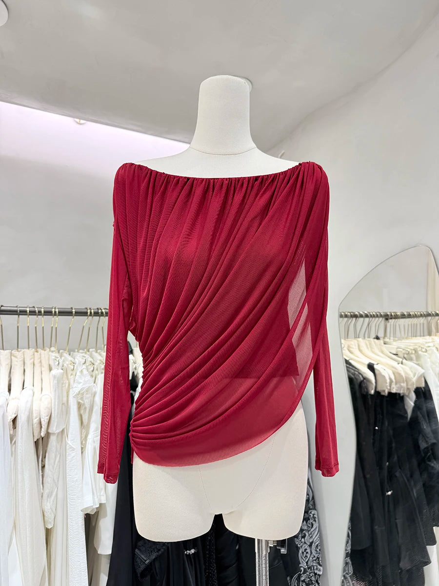 Red off-shoulder top on a mannequin in a clothing store setting