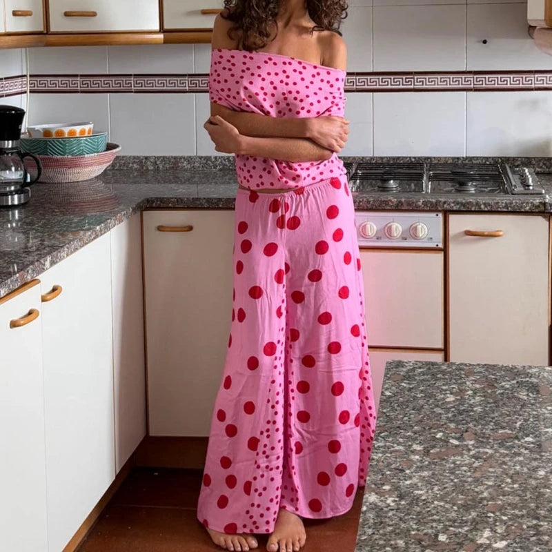 Person wearing a pink polka dot dress in a kitchen