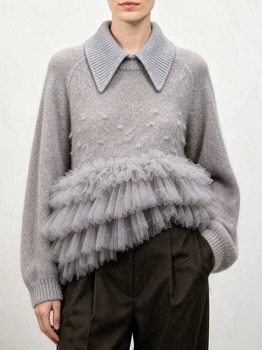 Gray knit sweater with a structured collar and a layered gray tulle ruffle detail at the waist.