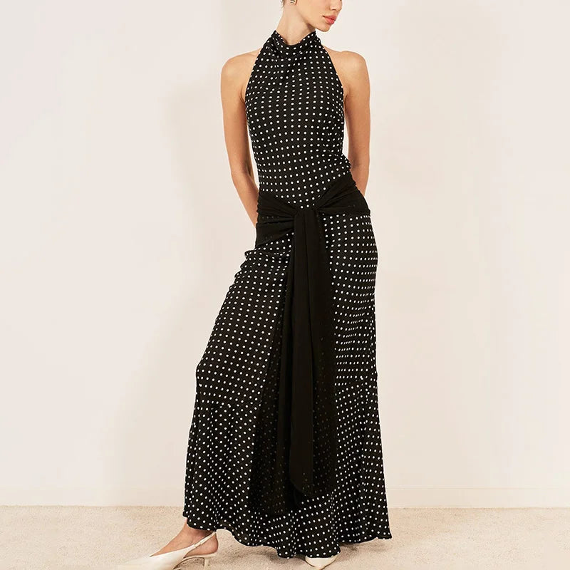 Black and white polka dot halter jumpsuit on a plain background