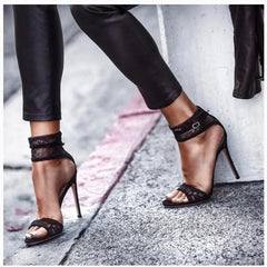 Model wearing black lace stiletto heels with trousers