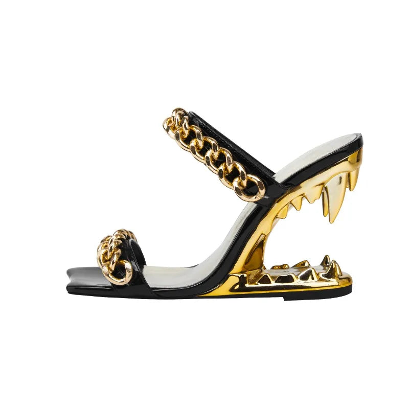 Black and gold high-heeled sandal with chain detail on a white background