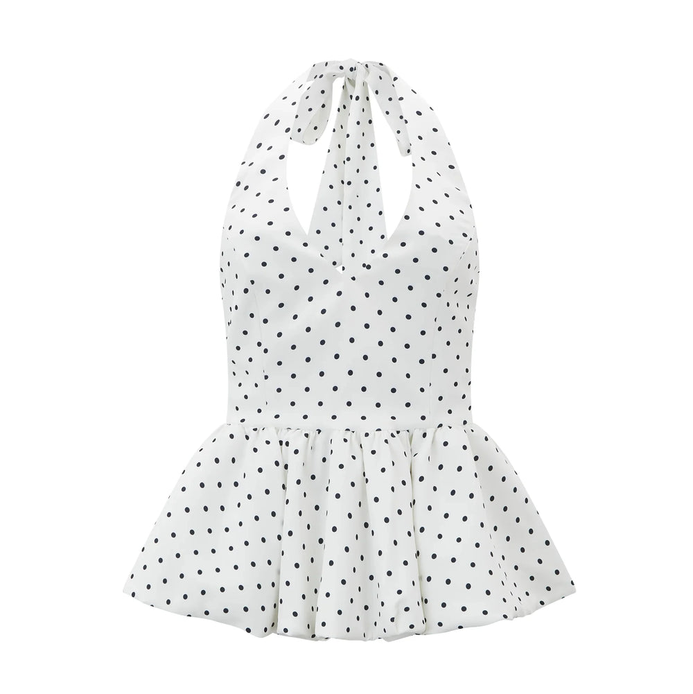 White halter neck dress with black polka dots on a white background