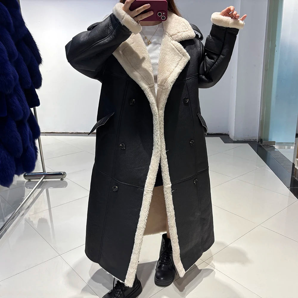Person wearing a long black coat with white fur lining in a store setting.