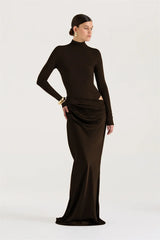 Woman wearing a black long-sleeve gown on a white background