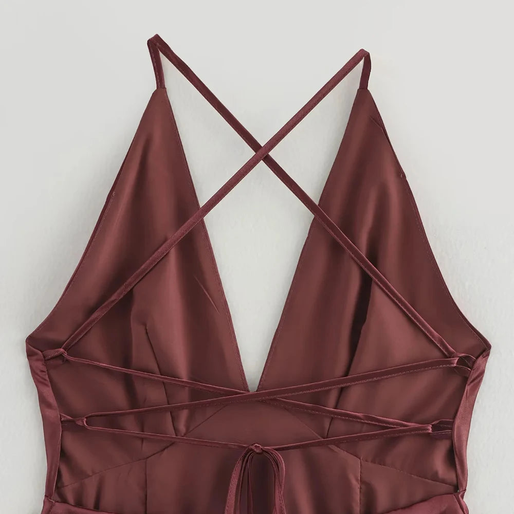 Maroon halter top with criss-cross straps on a light gray background