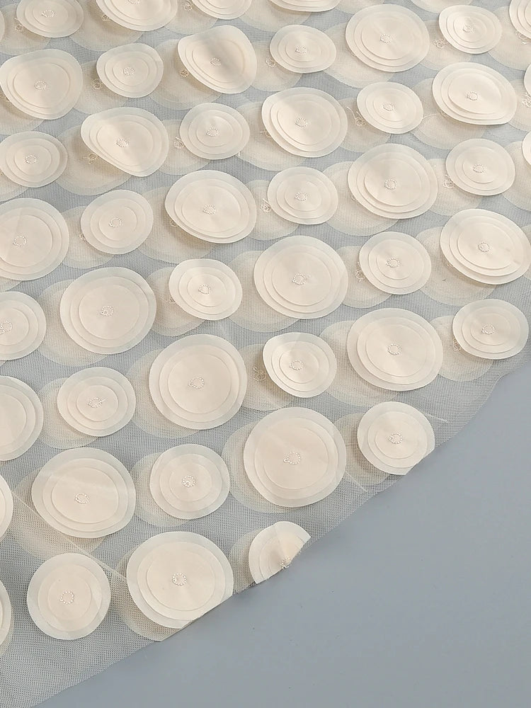 White circular adhesive strips on a gray background