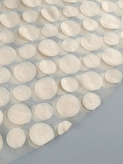 White circular adhesive strips on a gray background