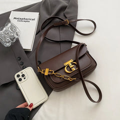 Compact retro handbag on gray blazer, ideal for city commutes