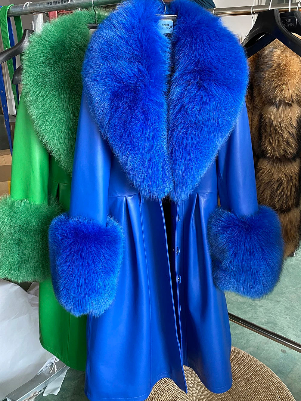 Blue coat with blue fur trim on a rack