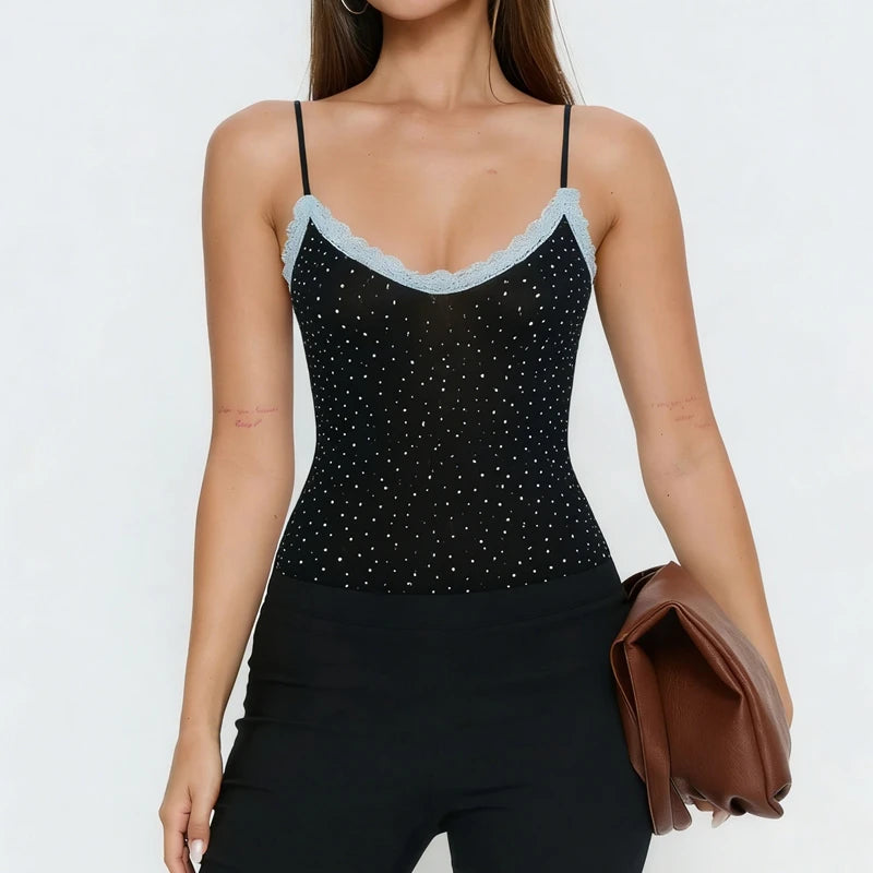 Black sparkly top with thin straps worn by a model on a white background