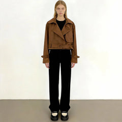 Front view of a woman wearing a brown faux leather cropped jacket