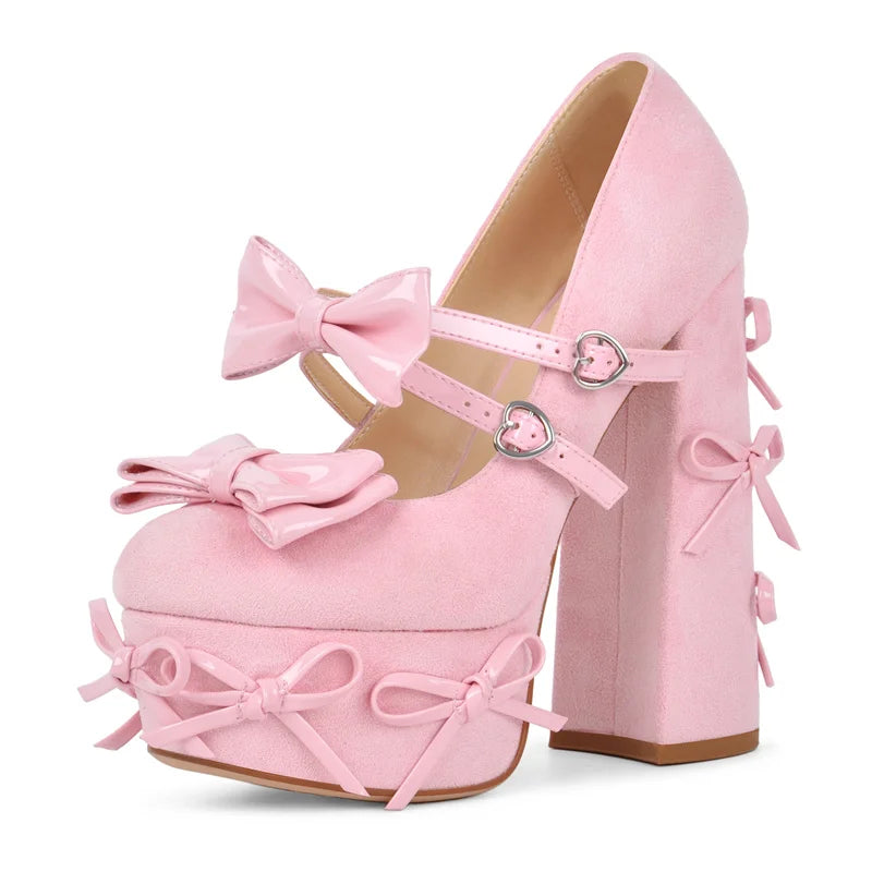 Side view of pink faux suede platform Mary Jane heels with patent bow accents.