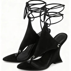 Black wedge sandals with lace-up design on a white background