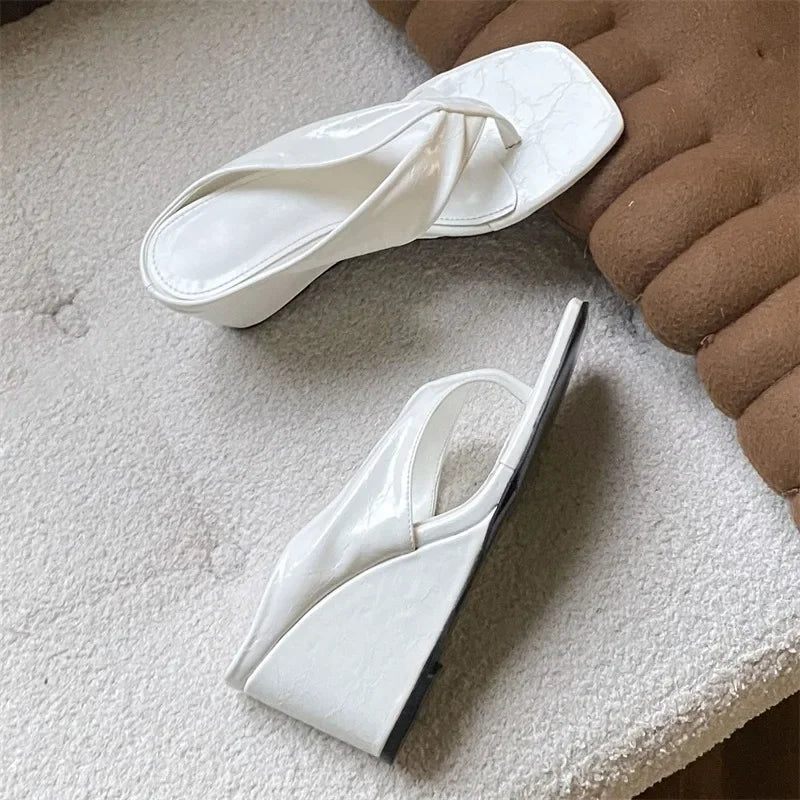 White square toe wedge flip flops shown from the side