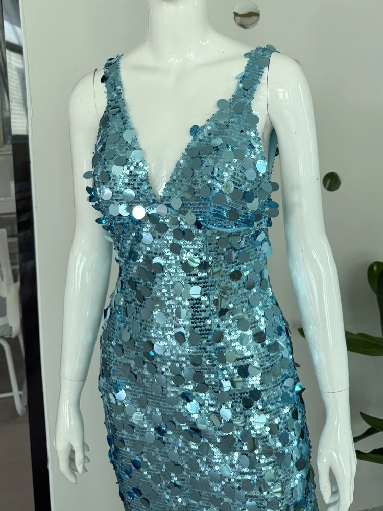 Mannequin wearing a blue sequin dress against a neutral background